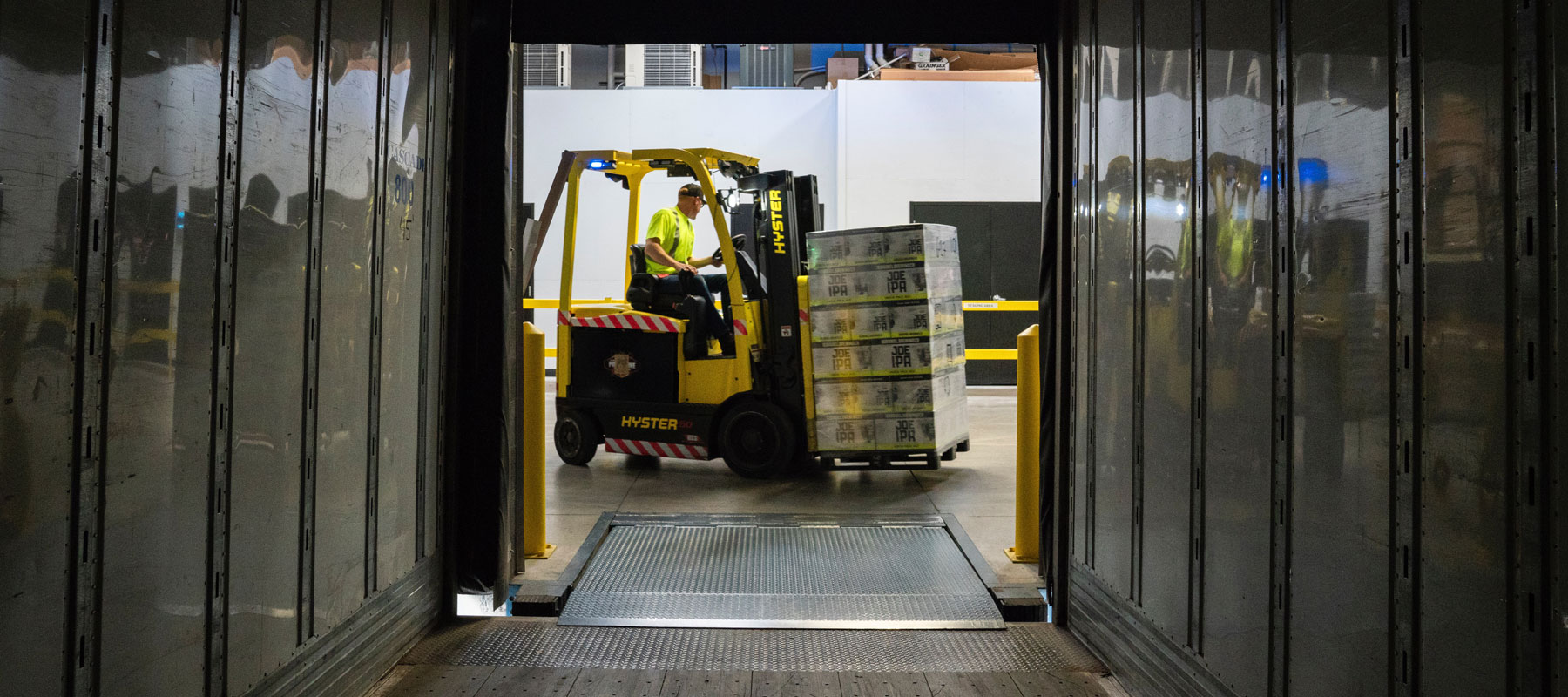 Forklift Operator Moving Pallet of Merchandise